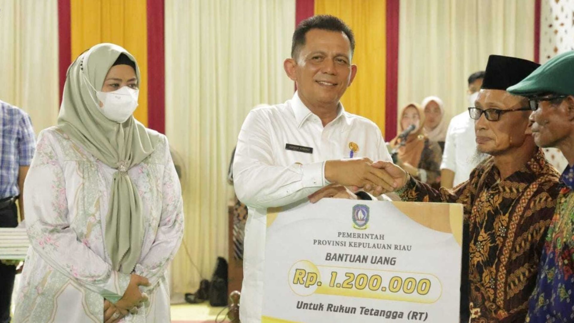 Gubernur Kepri Ansar Ahmad menyerahkan bantuan untuk RT/RW di Batam. (Foto: Diskominfo Kepri)