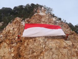 Basarnas Natuna Kibarkan Bendera Merah Putih Raksasa di Puncak Tebing Teluk Depeh